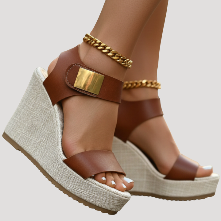 Close-up of tan wedge sandal with gold buckle accent and braided platform