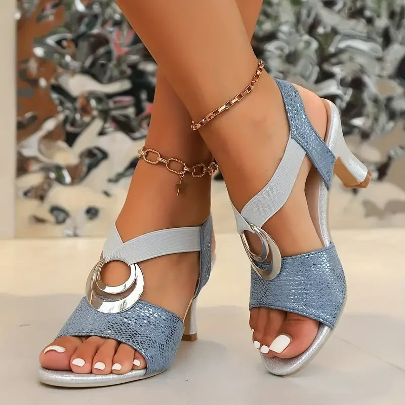 Light blue snakeskin sandals featuring chunky heel and silver ring accent