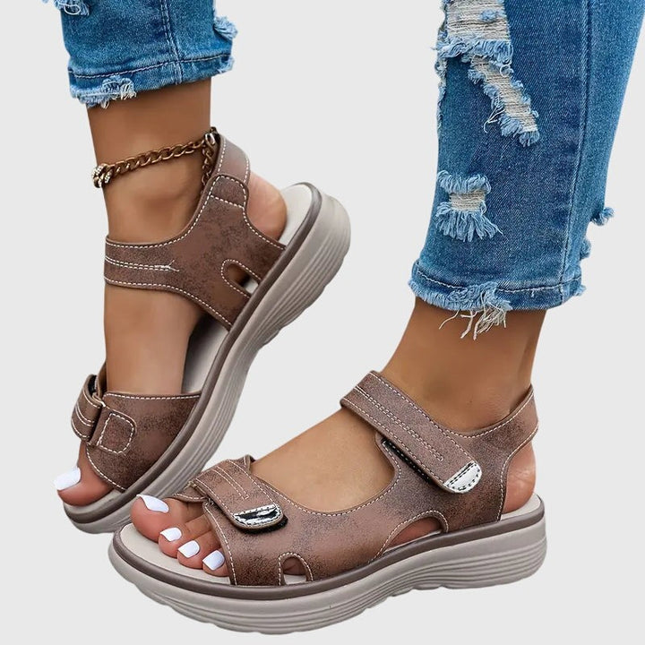 Brown orthopedic sandals with adjustable Velcro straps and platform sole