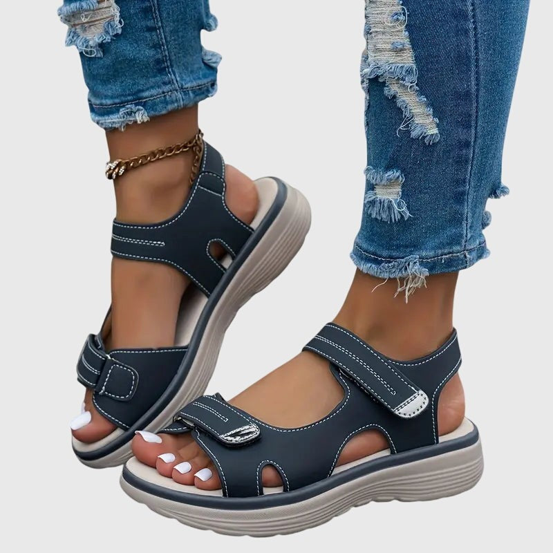 Navy blue platform sandals featuring contrast stitching and touch-close straps