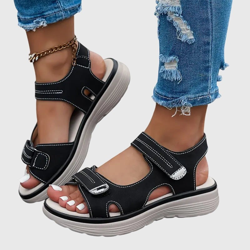 Black platform sandals with adjustable straps and topstitched detailing