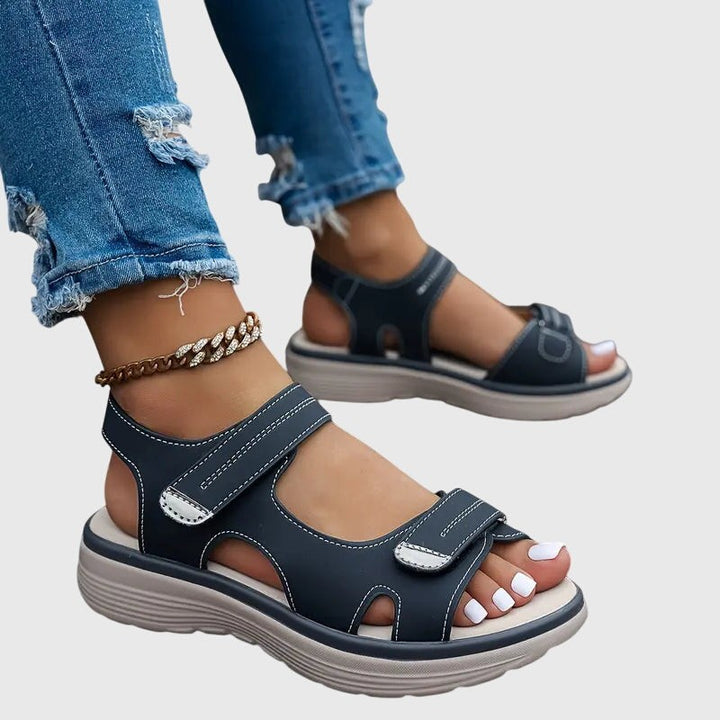 Navy blue orthopedic sandals with cutout sides and thick platform sole