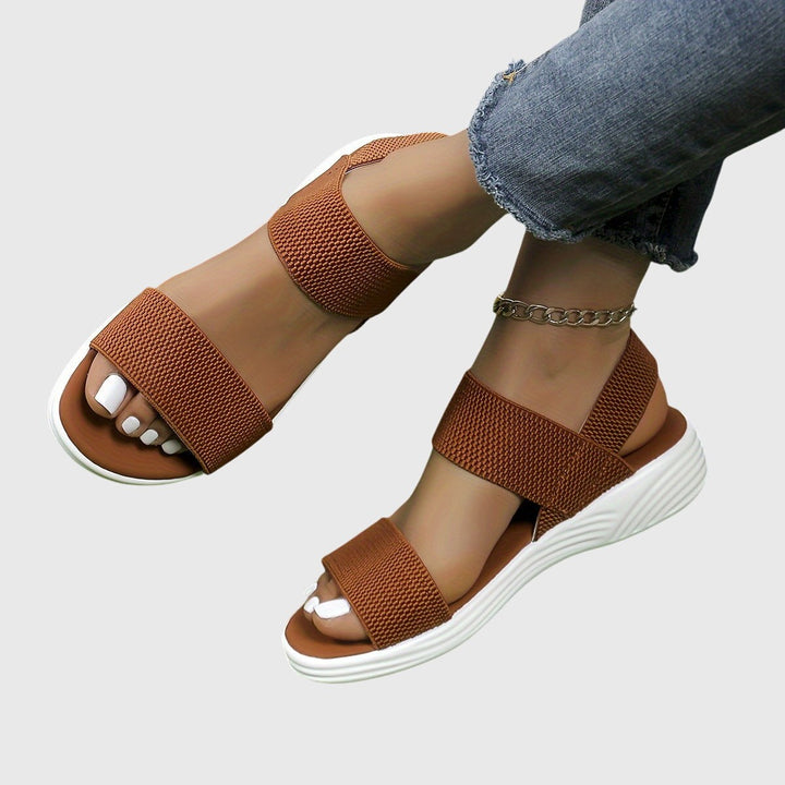 Cognac brown crisscross ankle strap sandals with white wedge platform sole