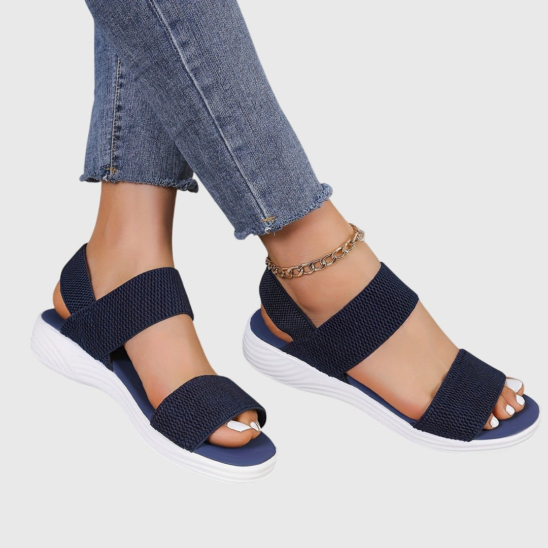 Navy blue crisscross ankle strap sandals with white platform wedge sole