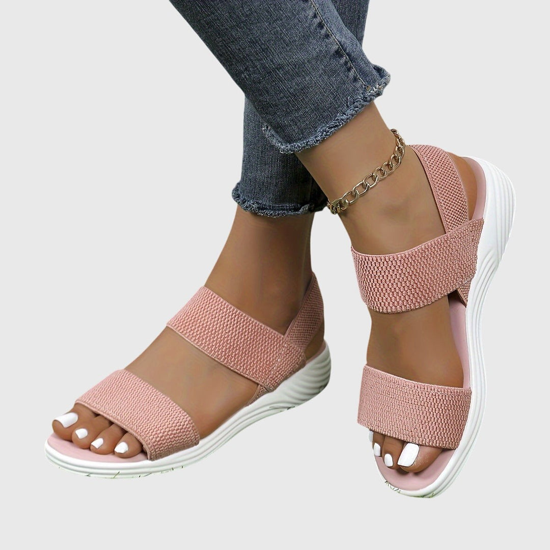 Blush pink woven strap sandals with white platform sole and ankle wrap
