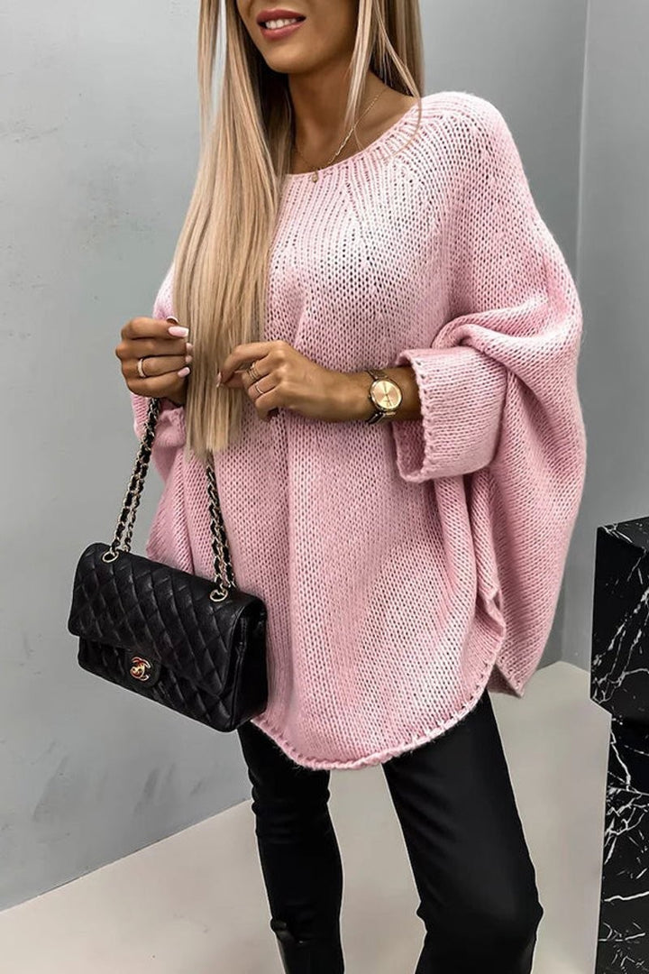 pink oversized knit sweater featuring loose batwing sleeves and a round crewneck