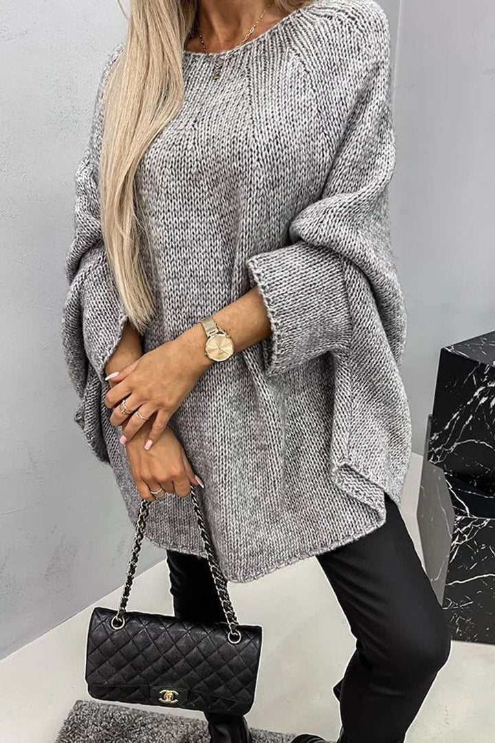 Gray chunky knit oversized sweater featuring wide batwing sleeves and curved hem