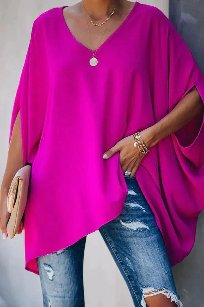 Hot pink oversized batwing-sleeve tunic top with V-neck and asymmetric hem