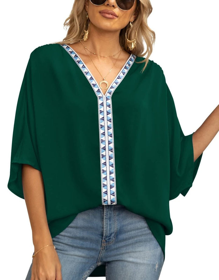 Emerald green relaxed tunic top with geometric trim neckline