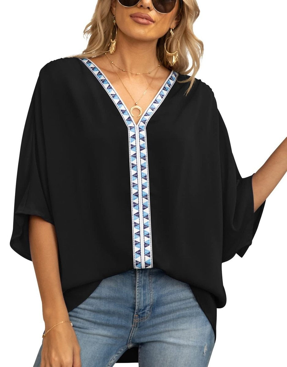 Black relaxed V-neck top with blue geometric trim detail
