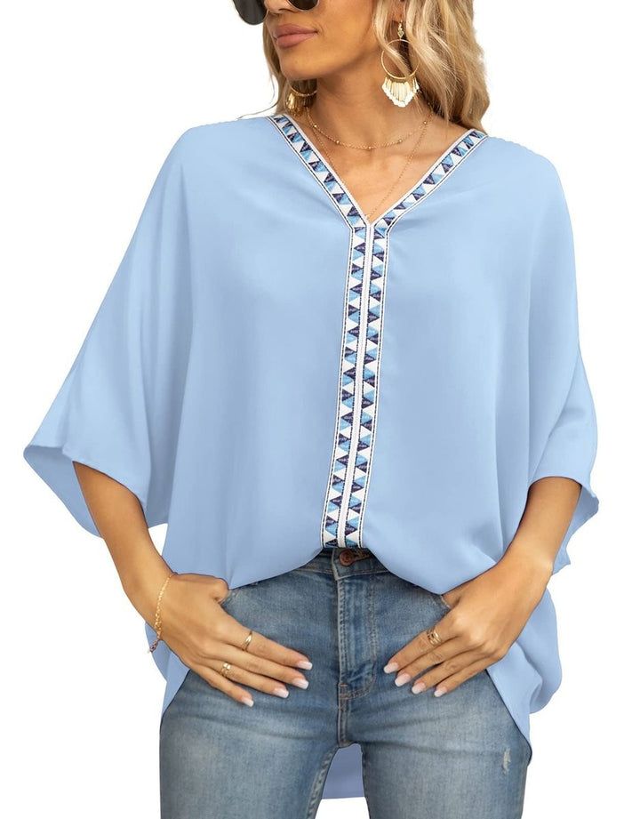 Sky blue V-neck top with geometric trim and high-low hem