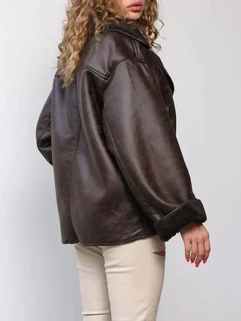 Side view of brown leather jacket showing fur-trimmed cuff and oversized fit