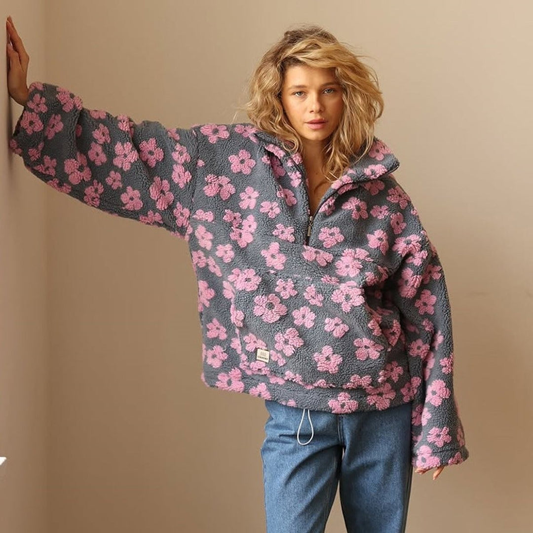 Oversized pink floral sherpa fleece pullover styled with straight-leg jeans