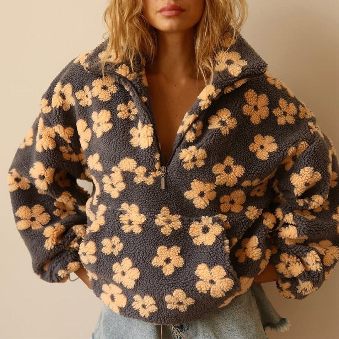Close-up of half-zip collar on grey and mustard floral sherpa fleece