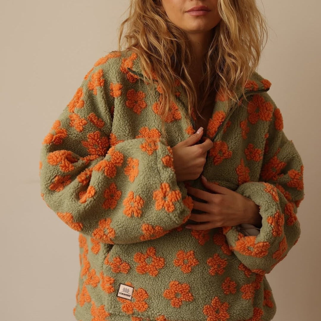 Close-up of front pocket and zip on khaki orange floral sherpa fleece