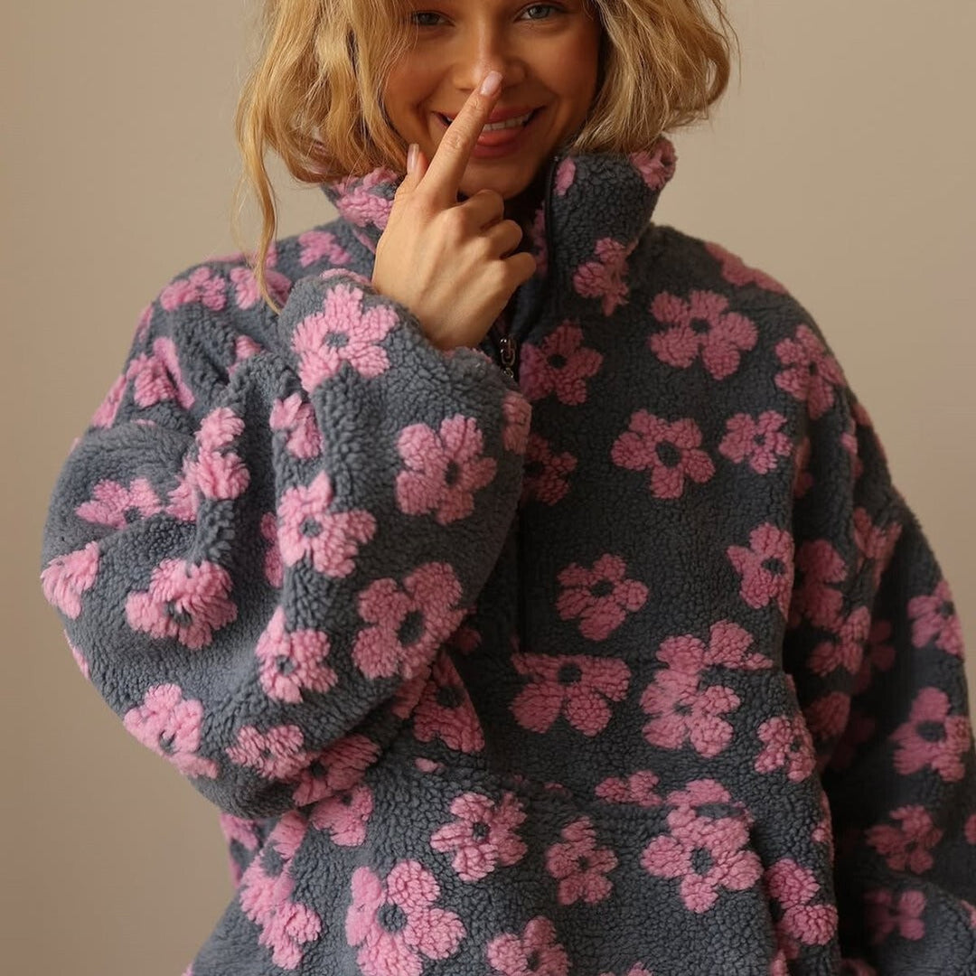 Close-up of high neck and zip on grey pink floral sherpa fleece pullover