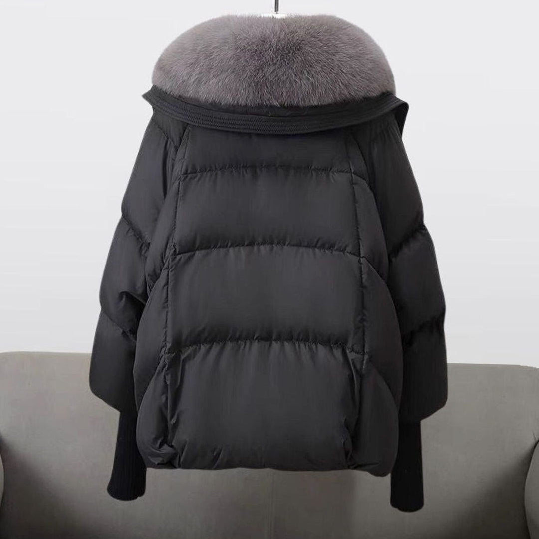 Back view of black puffer jacket showing quilted panels and fur-trimmed hood