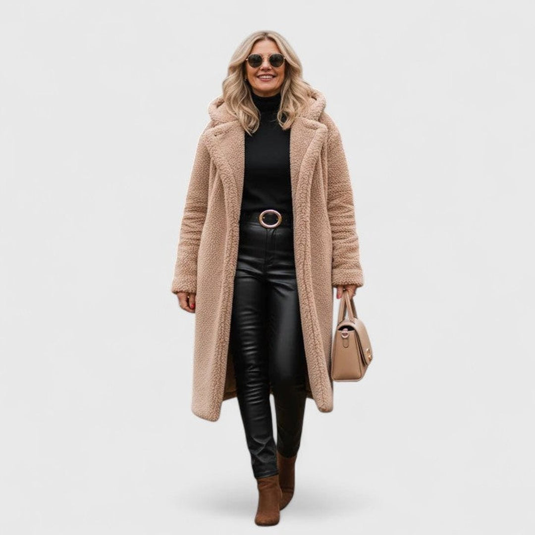 Tan textured teddy coat paired with black leather pants and boots