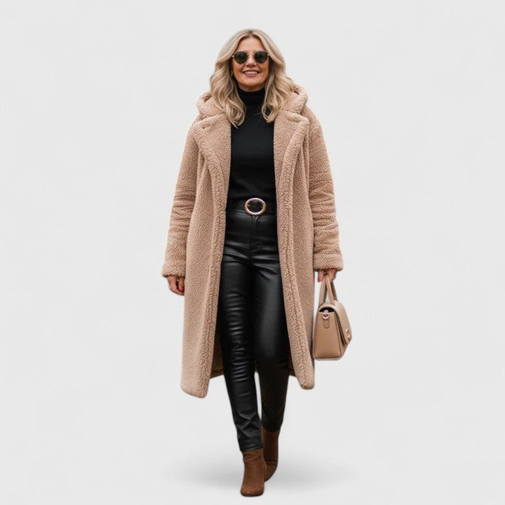 Tan textured teddy coat paired with black leather pants and boots