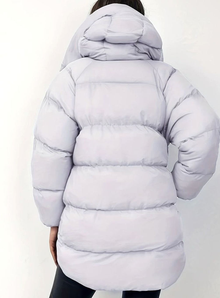 Pale grey oversized puffer jacket with hood, rear view showing quilted panels