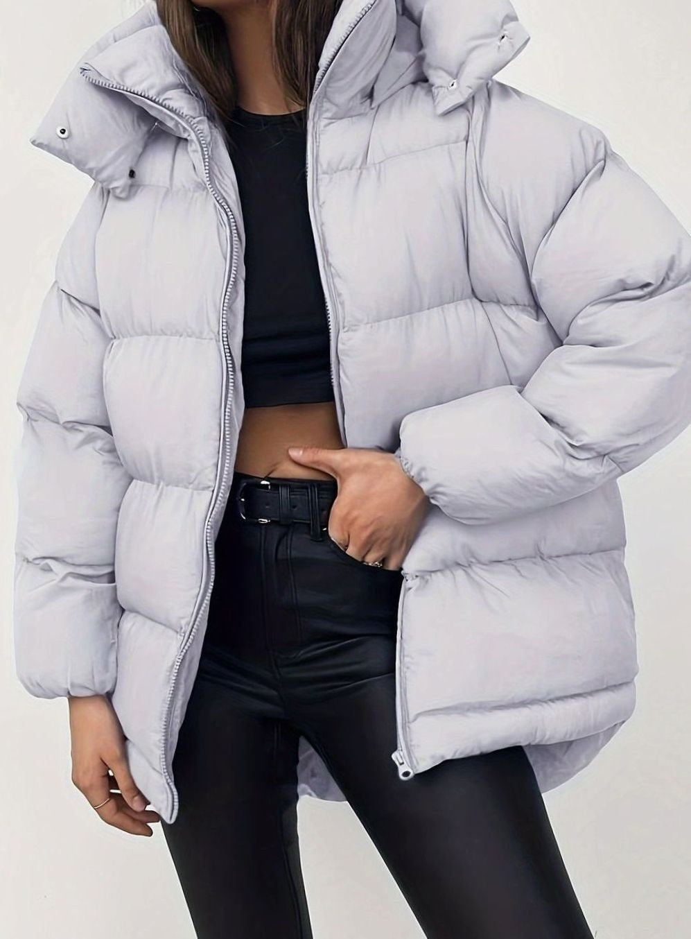 Pale grey quilted puffer jacket with stand collar worn over black crop top