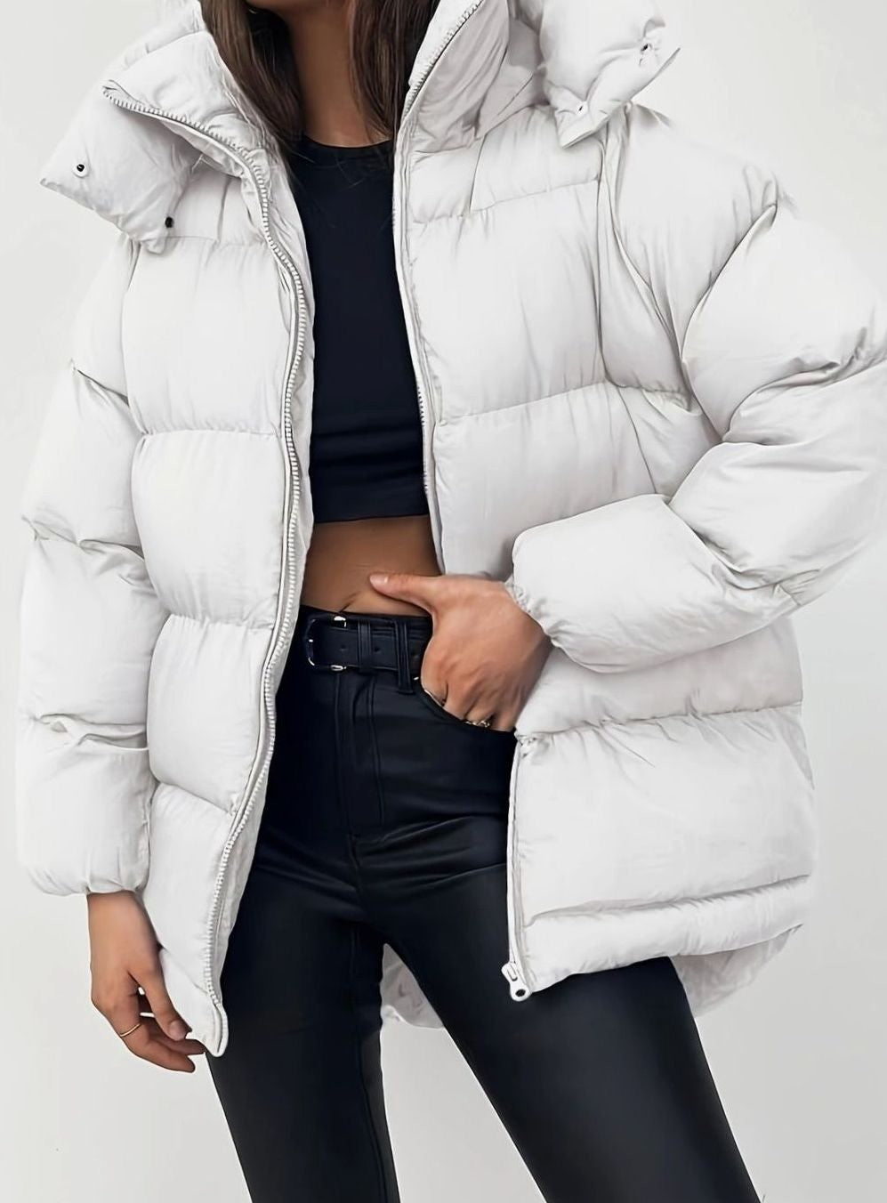 Off-white oversized puffer jacket with hood, styled with black leggings