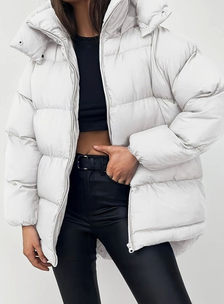 Off-white oversized puffer jacket with hood, styled with black leggings
