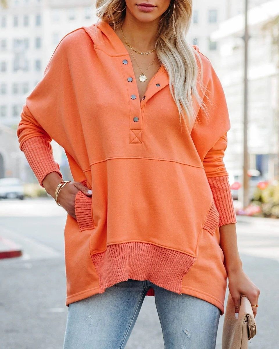 orange oversized hooded sweatshirt with ribbed pocket and snap-button neckline