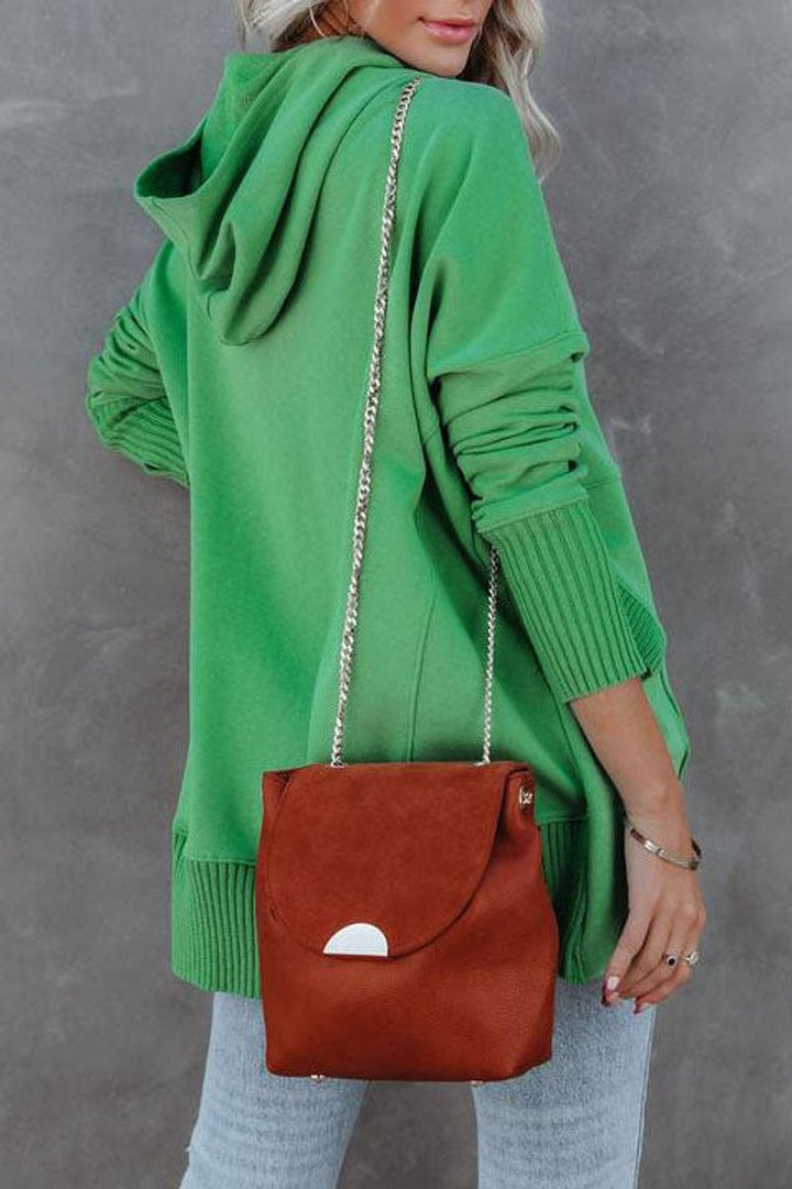 back view of green hooded tunic sweatshirt with crossbody bag strap