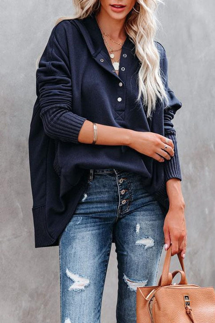 close-up of navy hoodie with snap-button placket and ribbed cuffs