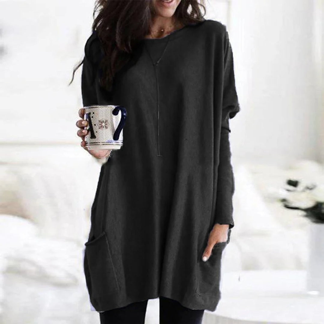 Black oversized tunic top featuring long sleeves and a front pocket
