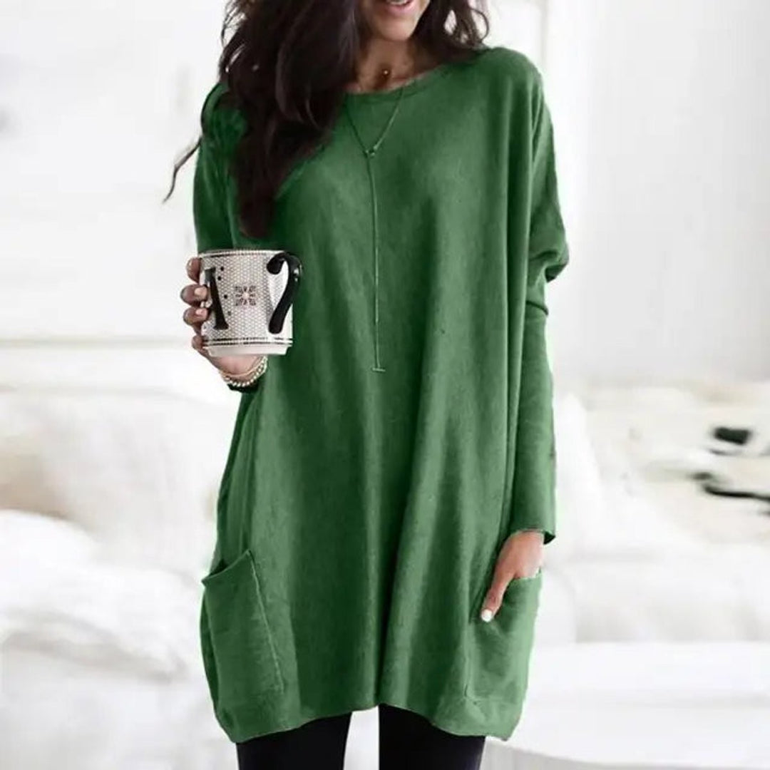 Green oversized tunic top featuring long sleeves and a front patch pocket