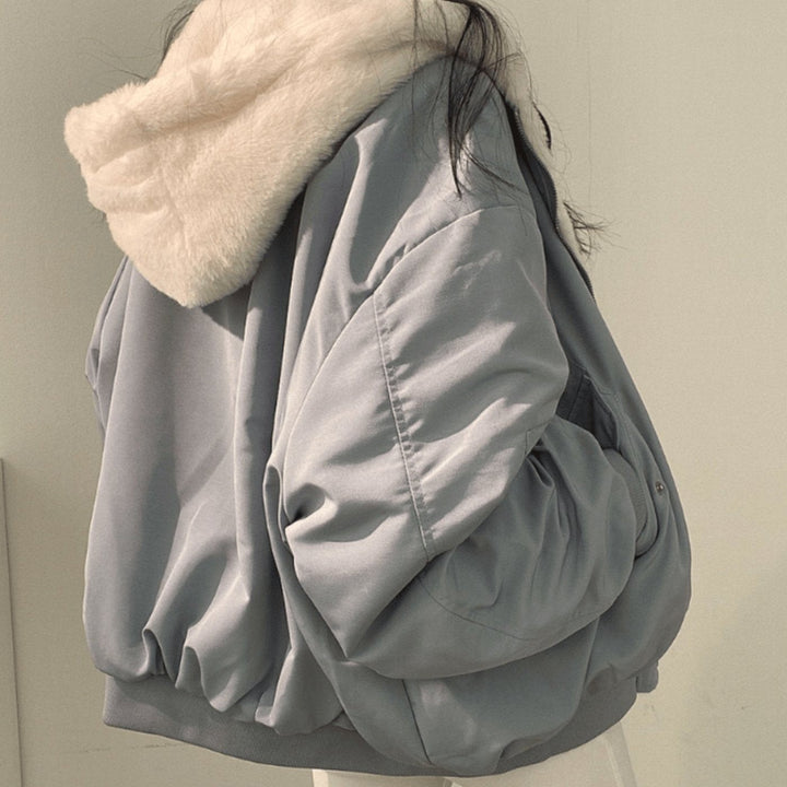 Slate-blue oversized bomber jacket with cream faux-fur hood, rear view