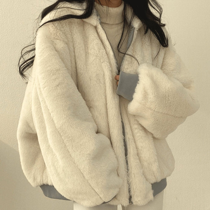 Oversized ivory faux-fur bomber jacket worn with grey trim cuffs