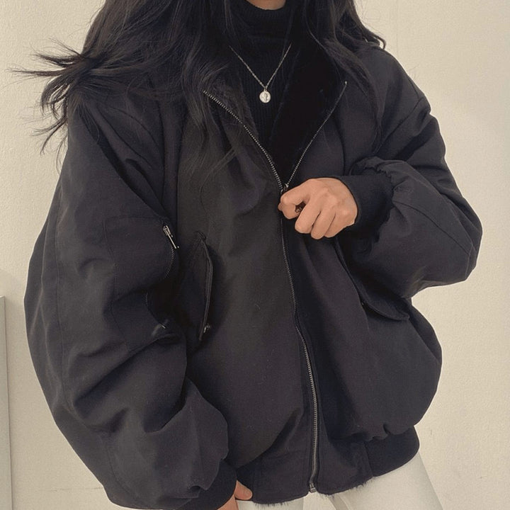 Black oversized bomber jacket with zip pockets and ribbed hem