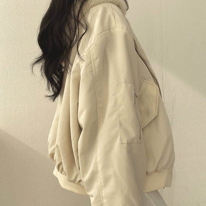 Cream oversized bomber jacket showing zip sleeve pocket detail