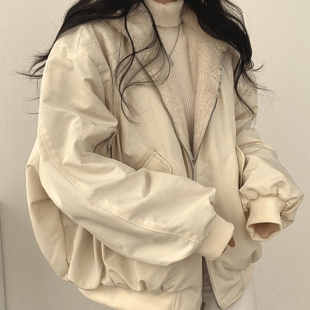 Reversible cream fleece-lined jacket worn open over ribbed jumper