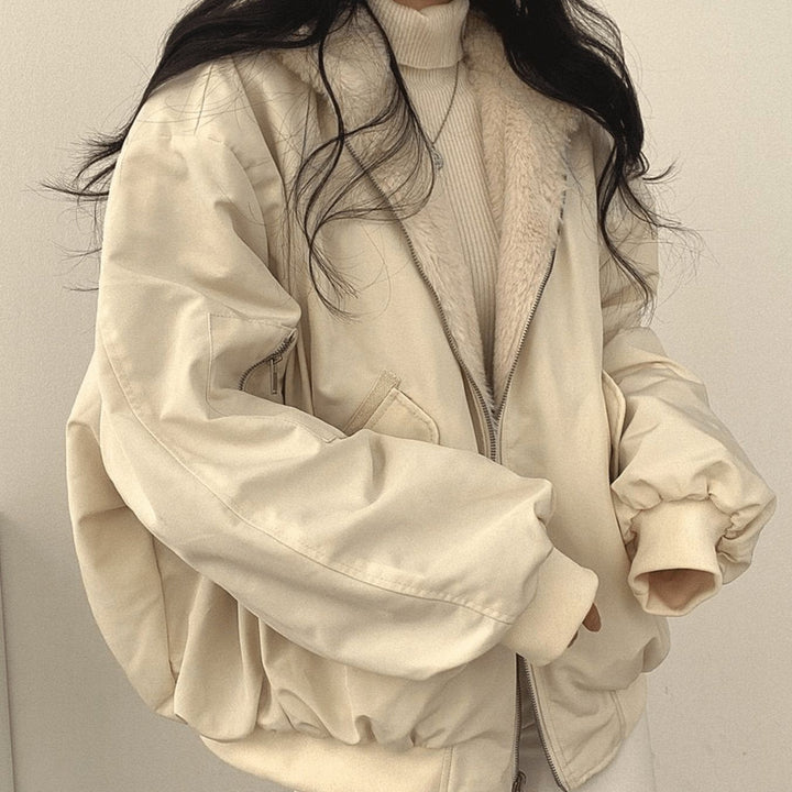 Reversible cream fleece-lined jacket worn open over ribbed jumper