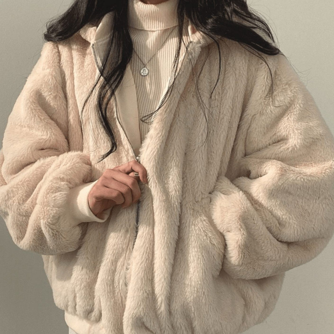 Blush pink faux-fur bomber jacket with silver zip, front view