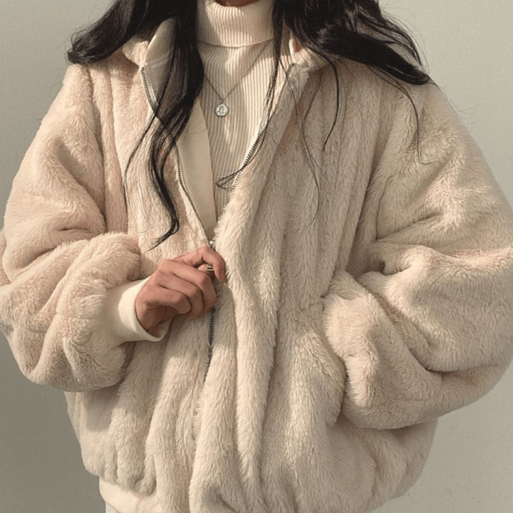 Blush pink faux-fur bomber jacket with silver zip, front view