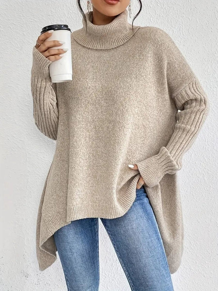 Beige oversized turtleneck sweater with ribbed trim and asymmetrical hemline
