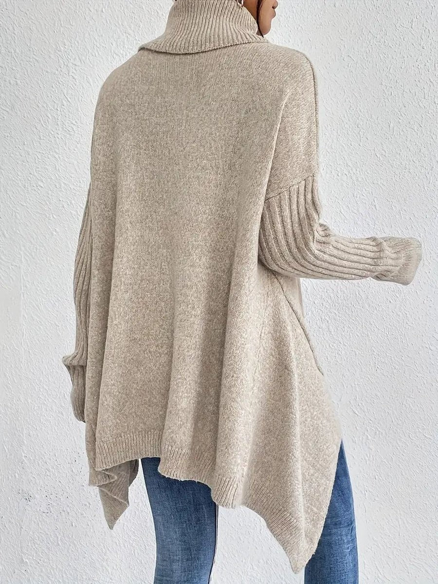 Back view of beige oversized turtleneck sweater with ribbed sleeves and draped hem