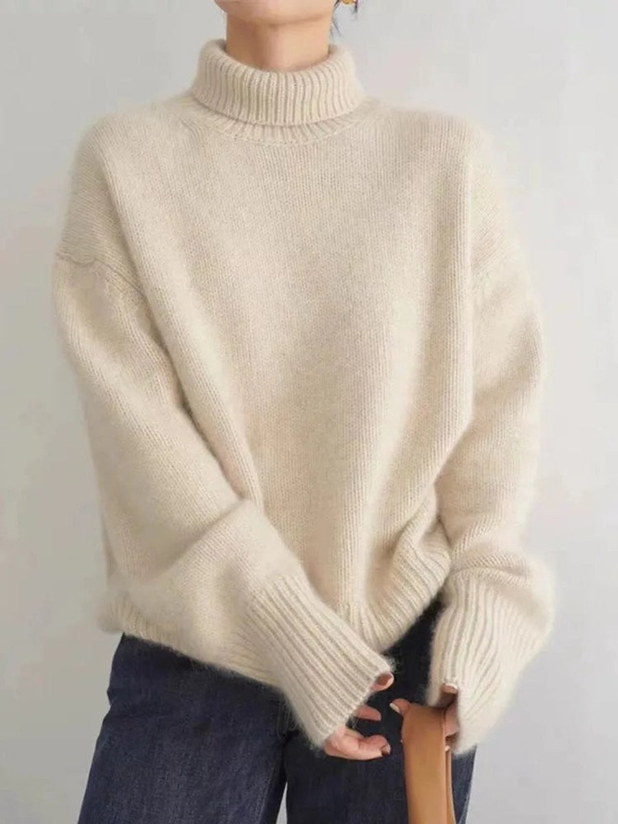 Ivory chunky knit turtleneck sweater featuring dropped shoulders and ribbed hem