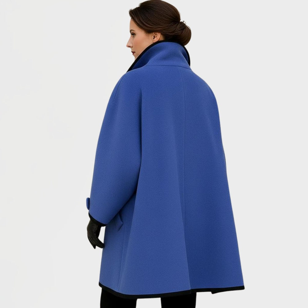 back view of blue wool-blend coat showing oversized silhouette and contrast trim