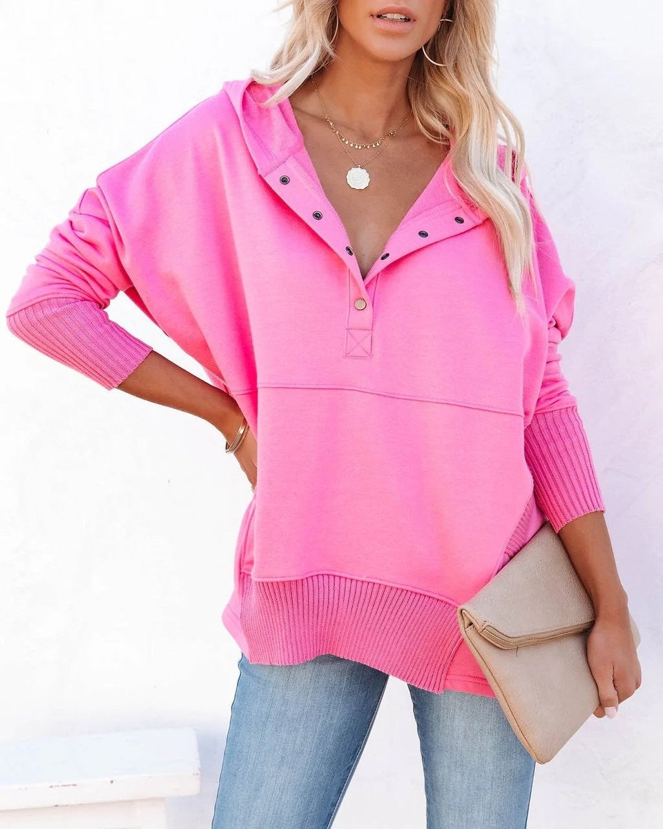 Bright pink oversized hoodie with snap placket and ribbed cuffs
