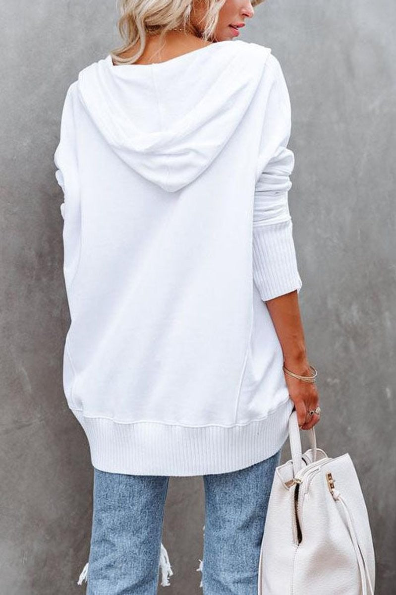 Back view of white oversized hooded sweatshirt with ribbed hem