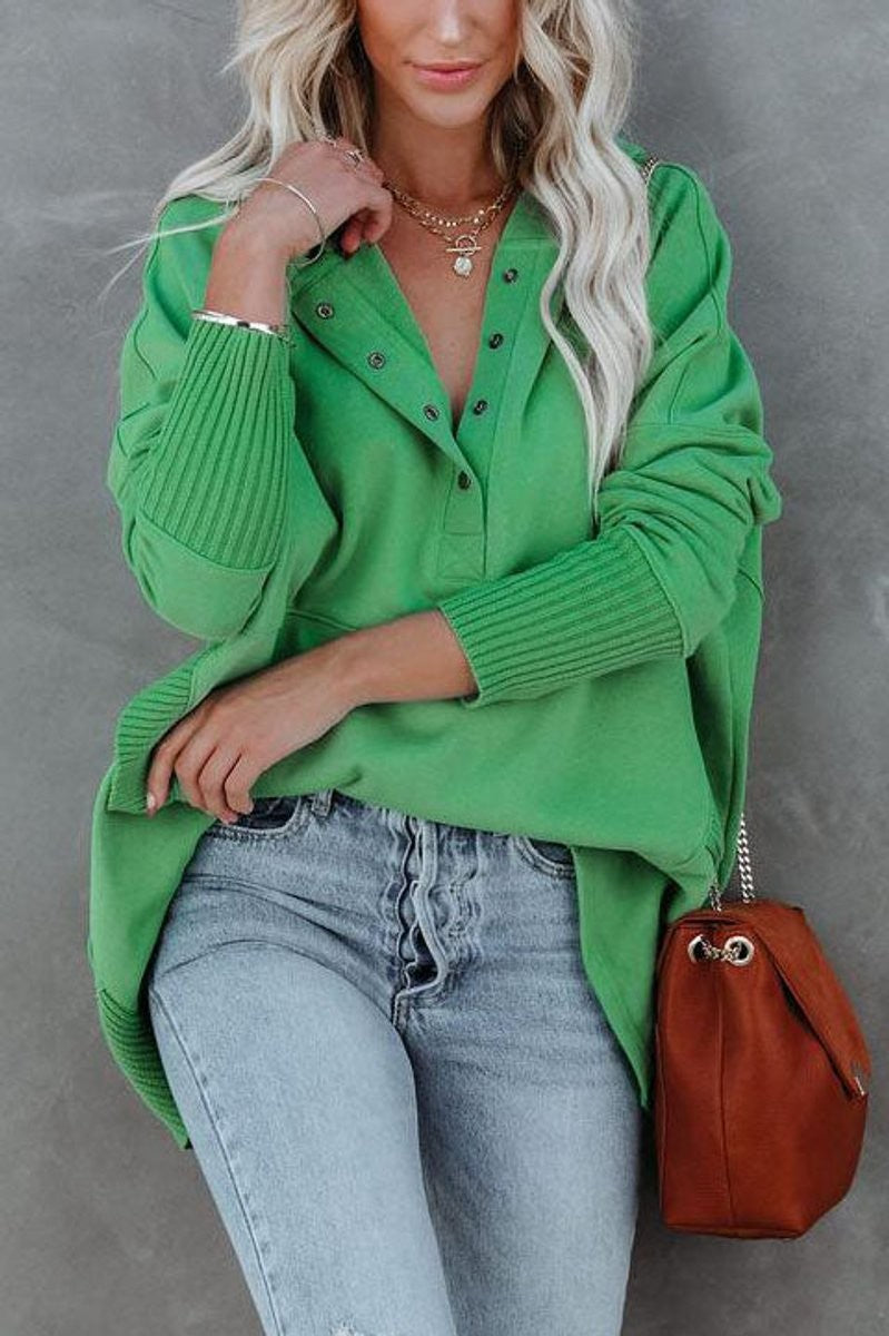 Close-up of green tunic hoodie showing snap button neckline