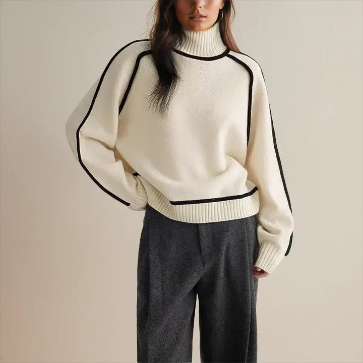 cream oversized turtleneck sweater featuring black piping seam design