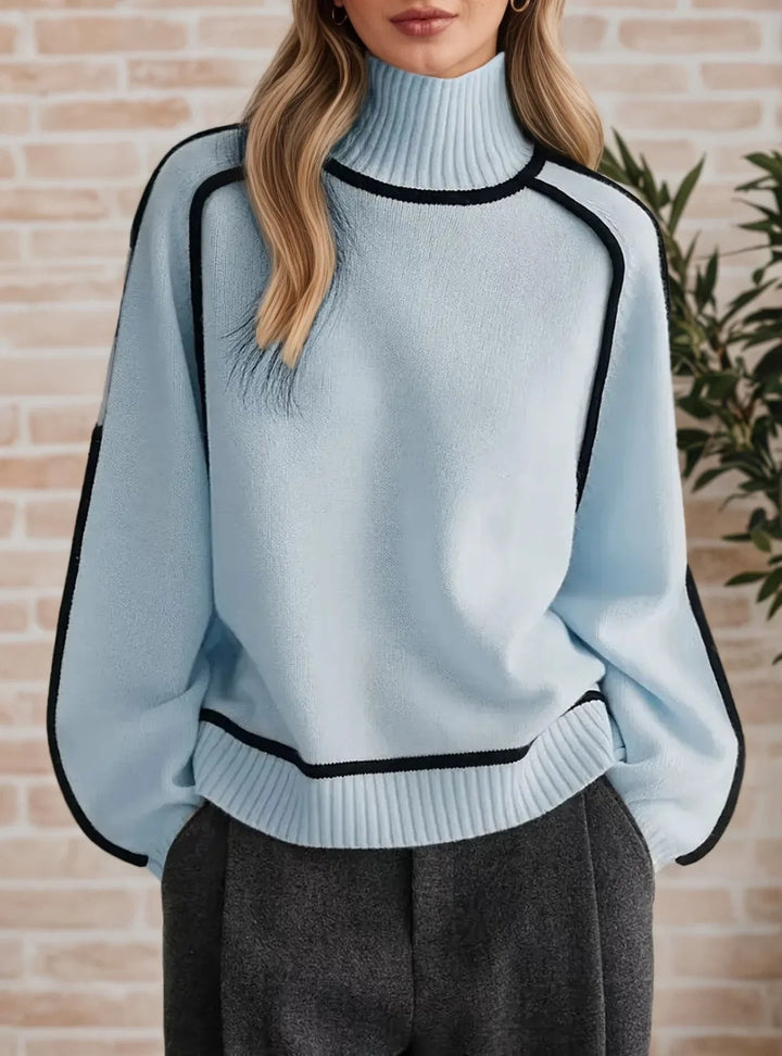 light blue oversized turtleneck sweater with black contrast piping accents