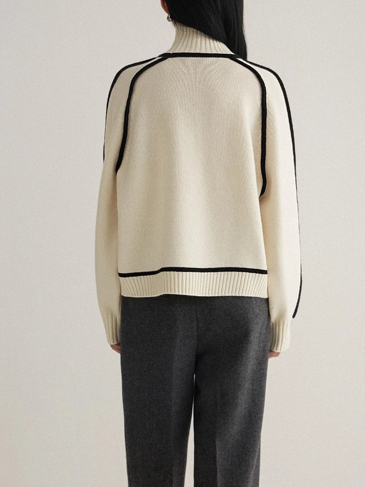 back view of cream oversized turtleneck sweater with black trim